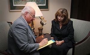 Woman meeting with Cedar Memorial Staff member